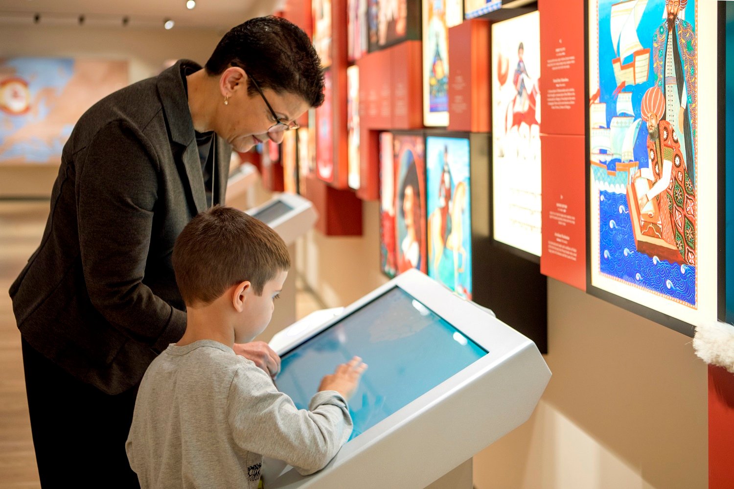 Visitors use an interactive display at ANU – Museum of the Jewish People