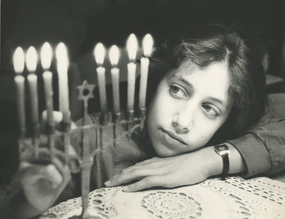 Girl admiring Hanukah candles, USA, 1970’s. Photo: Leni Sonnenfeld. Beit Hatfutsot, the Oster Visual Documentation Center, the Sonnenfeld collection