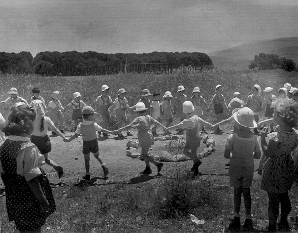 Children dancing around a bonfire on Lag Ba'omer, Mount Carmel, Haifa, Israel 1950s. Photo: Leni Sonnenfeld . Beit Hatfutsot, the Oster Visual Documentation Center, Sonnenfeld collection