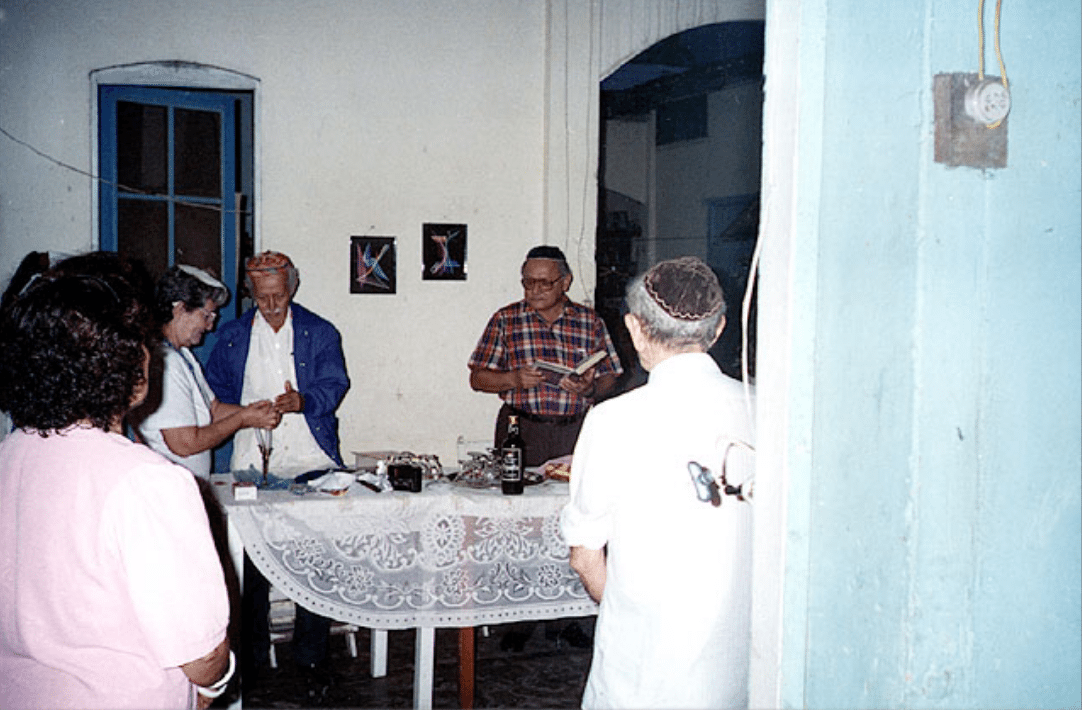 Lighting candles for Sabbath at the home of Victor Adri Morales, the spiritual leader of the community, Iquitos, Peru 1995. Photo: Ariel Segal. Beit Hatfutsot, the Oster Visual Documentation Center, courtesy of Ariel Segal, Jerusalem