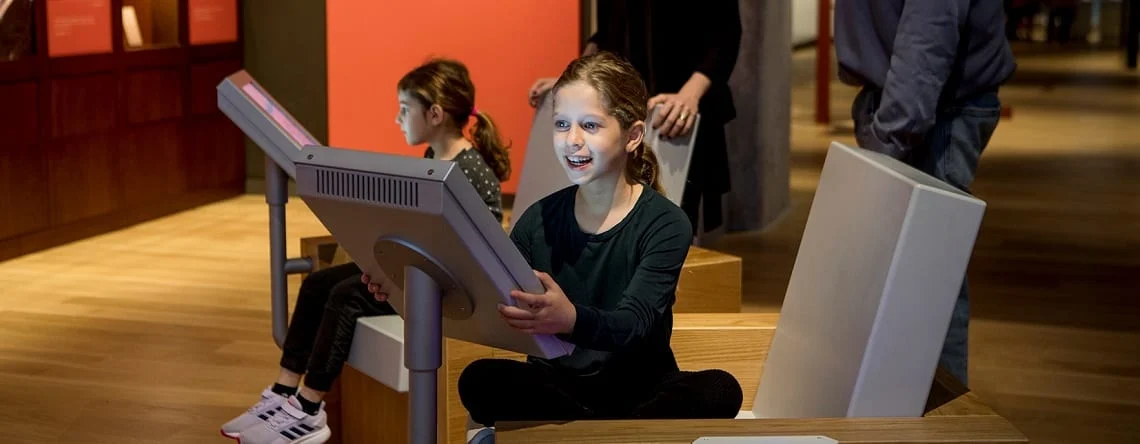 A Girl using an interactive display. ANU – Museum of the Jewish People