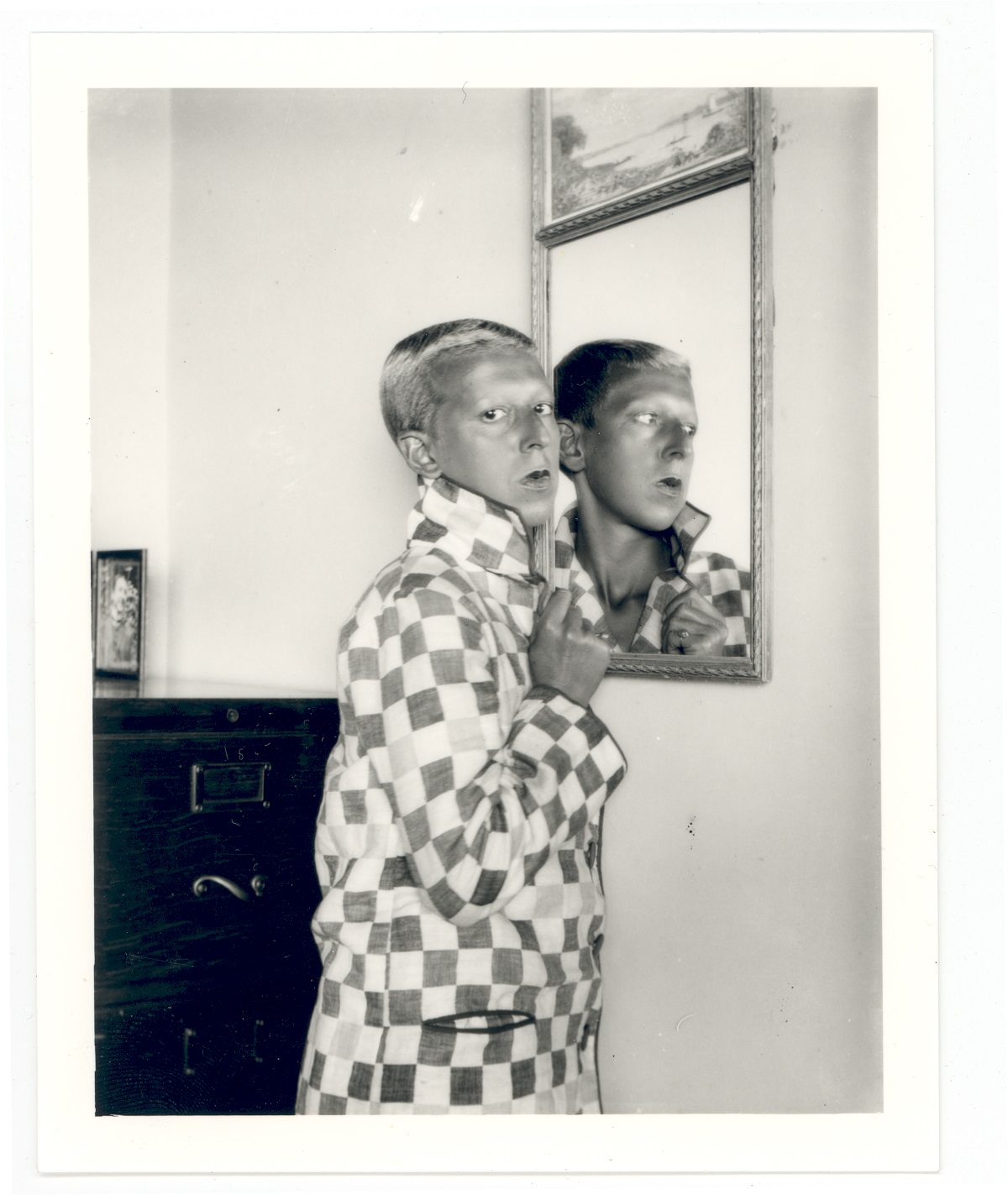 Claude Cahun, self portrait (reflected in mirror, chequered jacket) 1928